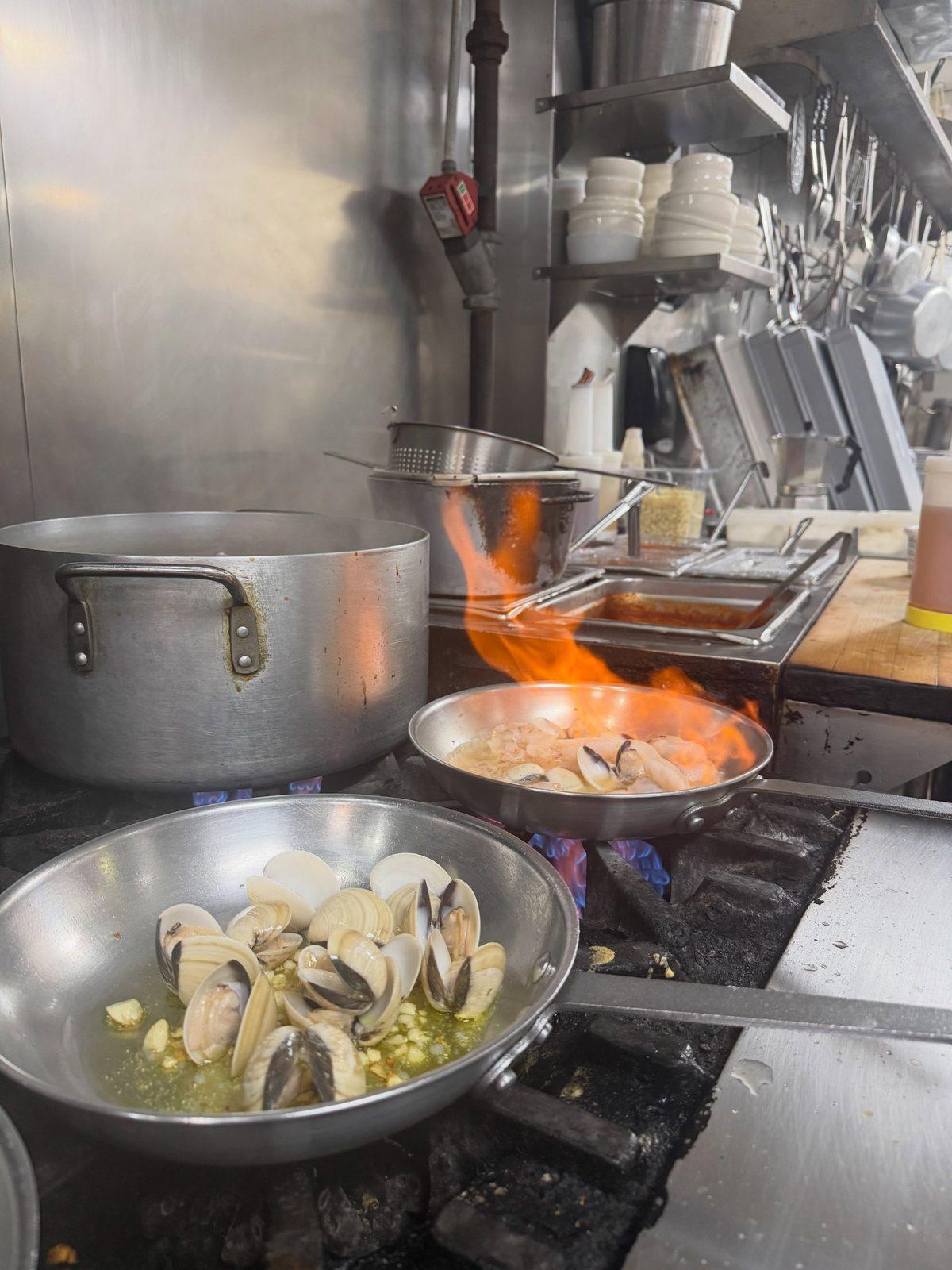 Clams cooking in a pan on the stove
